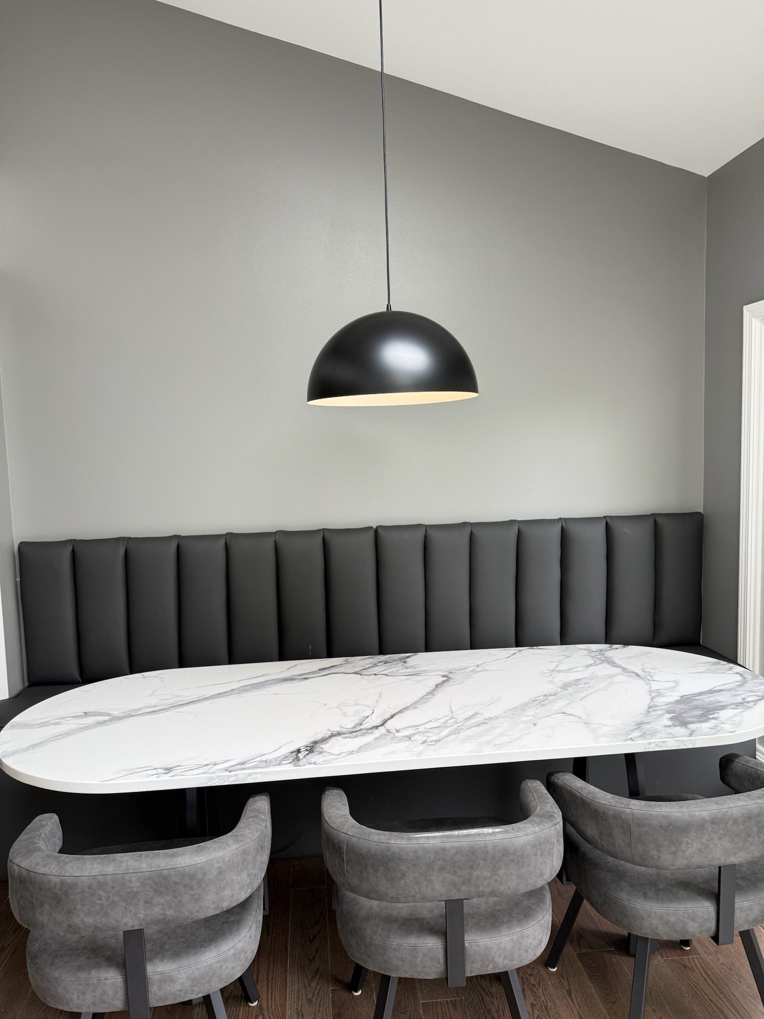 Custom banquette and quartz dining table in a remodeled kitchen